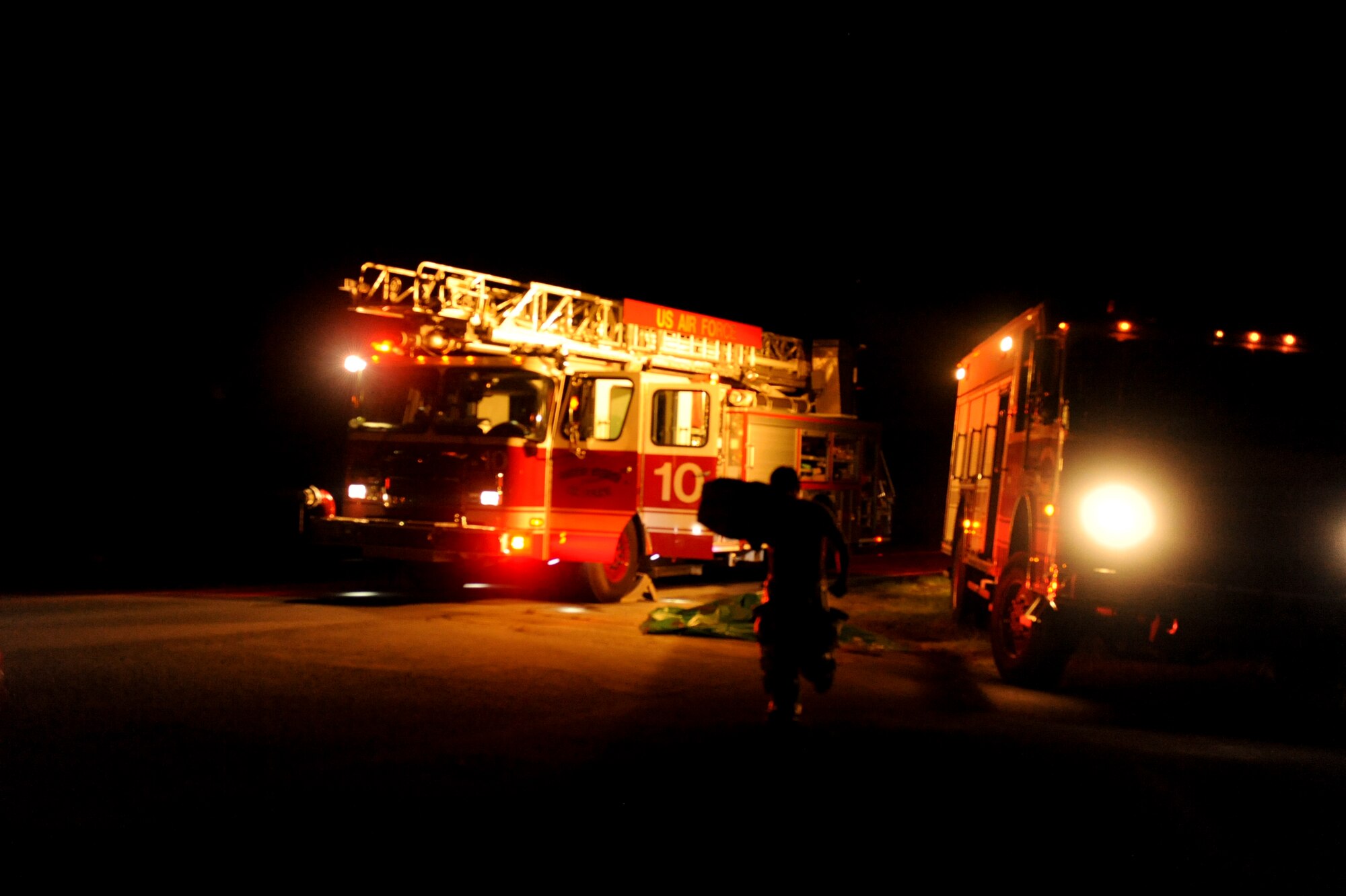 An 18th Civil Engineer Squadron firefighter rushes a litter to an exercise inject during local operational readiness exercise Beverly High 12-5 on Kadena Air Base, Aug. 21, 2012. Airmen use LOREs to train on a multitude of scenarios in order to prepare them for real world contingencies. (U.S. Air Force photo/Airman 1st Class Brooke P. Beers)
