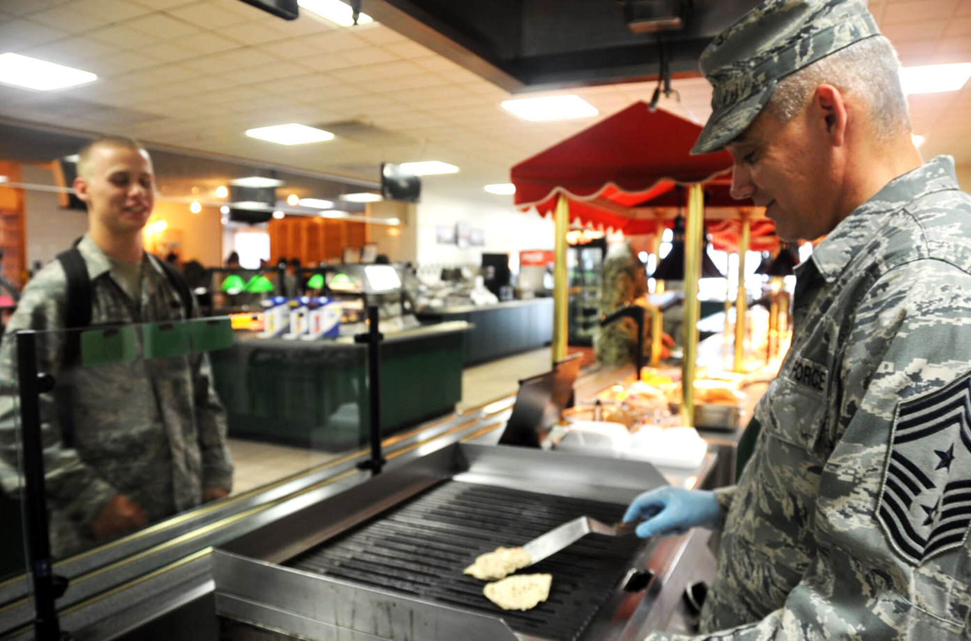 U.S. Air Force Chief Master Sgt. James Laurent, 35th Fighter Wing command chief, grills chicken in the Grissom Dining Facility at Misawa Air Base, Japan, Aug. 21, 2012. Laurent serves as the senior enlisted advisor to the 35 FW and Misawa Air Base installation commander. However, every now and again, Laurent likes to trade his speech notes for a spatula and show his talents in the kitchen. (U.S. Air Force photo by Airmen 1st Class Kenna Jackson/Released)