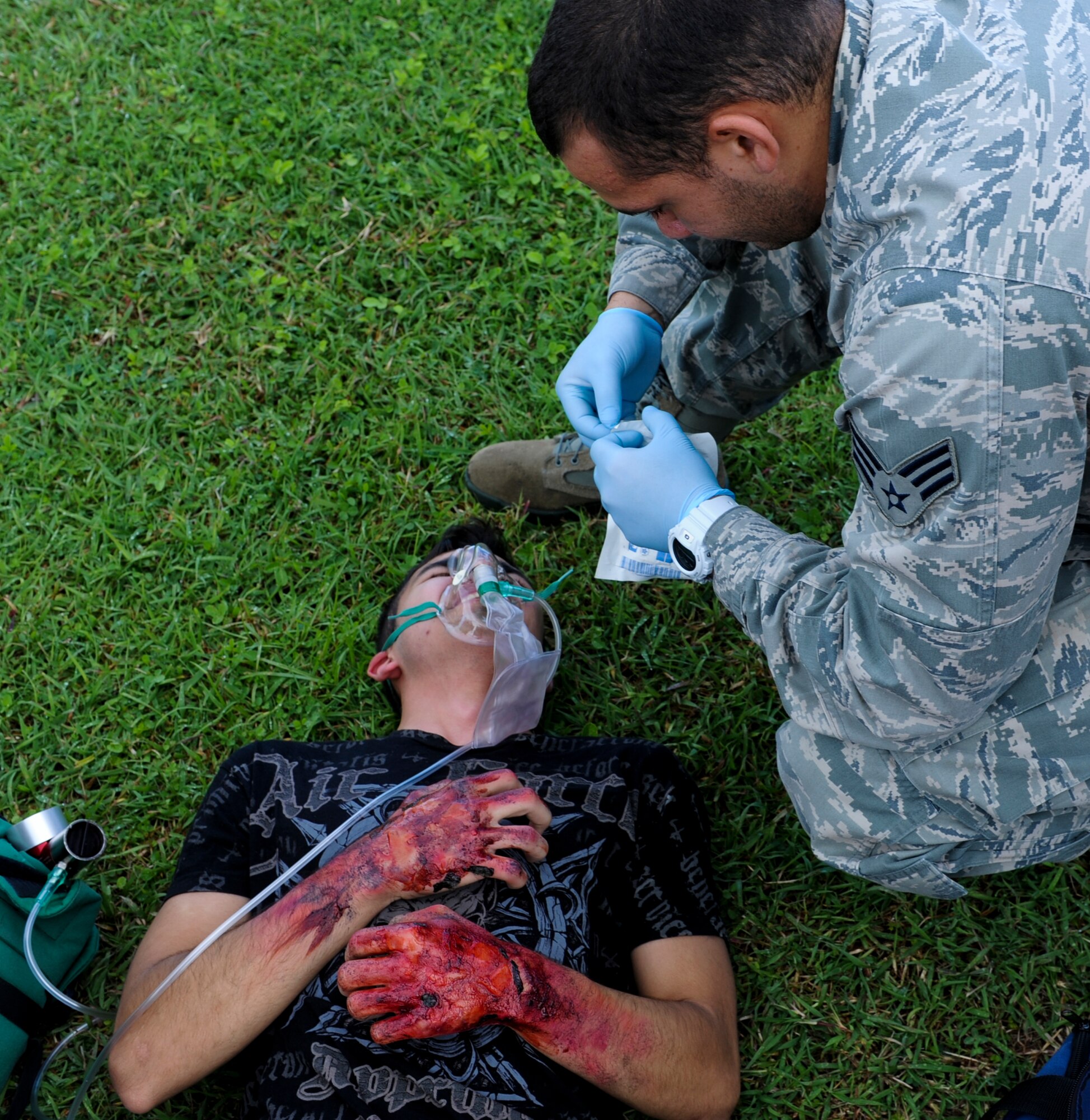 U.S. Air Force Senior Airman William Dominguez, 18th Medical Operations Squadron emergency medical technician, treats Senior Airman Tim Kurillo, 82nd Reconnaissance Squadron aircraft hydraulics technician and simulated victim, during Beverly High 12-5, a local operational readiness exercise on Kadena Air Base, Japan, Aug. 21, 2012. The week-long exercise is designed to test Kadena Airmen on their ability to survive and operate in a multitude of scenarios in order to prepare them for real world contingencies. (U.S. Air Force photo/Airman 1st Class Justin Veazie)