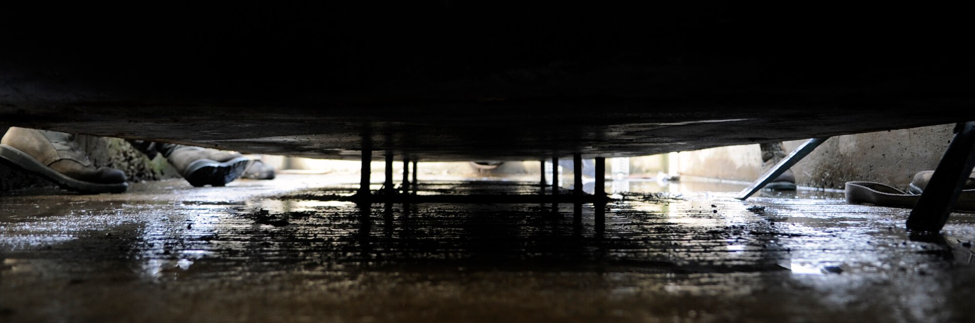 An aircraft arresting system is moved into place on pegs by Airmen from the 8th Civil Engineer Squadron at Kunsan Air Base, Republic of Korea, Aug. 18, 2012. The heavy equipment, power production and structures shops worked together to make the emergency braking system once again functional. (U.S. Air Force photo/Senior Airman Brigitte N. Brantley)