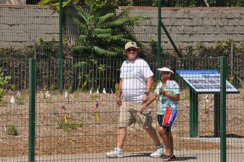 Residents stroll along the newly opened Tujunga Wash Greenway Aug. 15 in Valley Glen, Calif.  The project features 3.2 miles of public pathways, along with 18 acres of open space adjacent to the concrete channel that carries runoff from Hansen Dam to the Los Angeles River.
