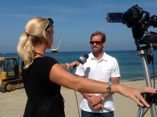 Jeff Cole, US Army Corps of Engineers manager for the Marina del Rey, Calif., entrance channel navigation dredging project, speaks with a reporter at Redondo Beach, Calif., about the project's placement of nearly 75,000 cubic yards of sand there. The Redondo phase of the project is part of a Corps navigational dredging project to remove about one million cubic yards of sediment at Marina del Rey to restore navigational safety for mariners and first responders. 