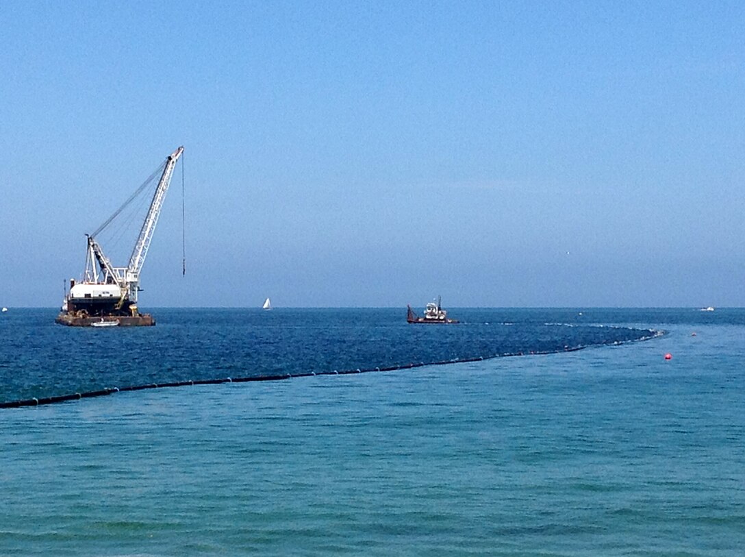 A pusher boat hauls nearly 1,500 feet of 12-inch rubberized pipe to the dredge Paula Lee just offshore from Redondo Beach, Calif., in preparation for the transfer of nearly 75,000 cubic yards of sand from a dredging project at the Marina del Rey entrance channel. This work is a phase of a project designed to remove about one million cubic yards from the channel and restore safe navigation for mariners and first responders who use the marina. The Redondo portion is scheduled to take abut 40 days. 