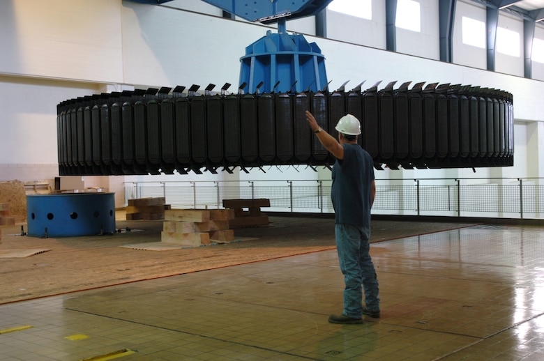 KUTTAWA, Ky. — A crewman with National Electric Coil from Columbus, Ohio guides a 270-ton rotor assembly onto a pedestal at the Barkley Dam Hydropower Plant here, Aug. 16, 2012. The U.S. Army Corps of Engineers Nashville District is rehabilitating a hydropower generator damaged in an electrical fire in January 2010. 