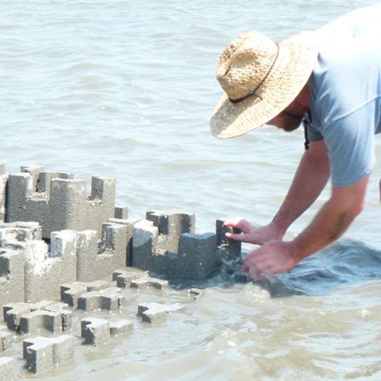 A Charleston District contractor works to construct the oyster castle wall.