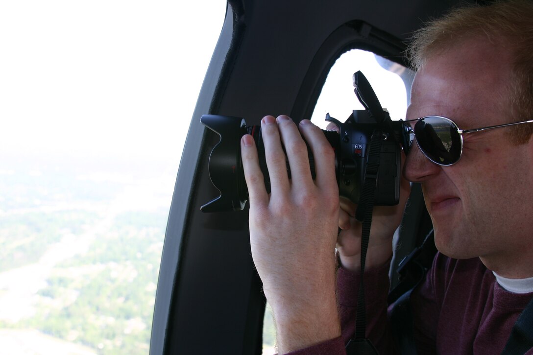 A member of the corporate communications team takes a ride in a helicopter to get photos and video to use in various projects.