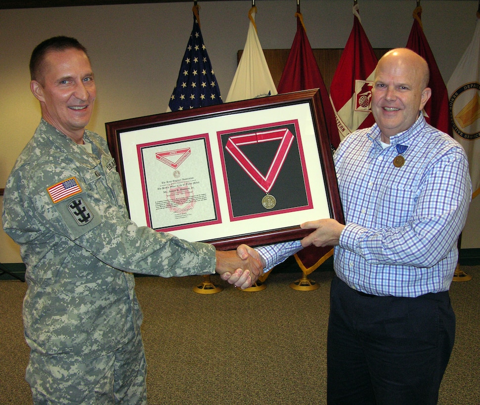 Brig. Gen. Thomas W. Kula, left, SWD commander, presents the Bronze de Fleury Medal to Mr. Jim Hannon for his many contributions at a farewell luncheon on  Aug. 17.  Hannon, who was serving as the director of Regional Business, has become the chief of Operations for the U.S.  Army Corps of Engineers Headquarters in Washington, D.C. 