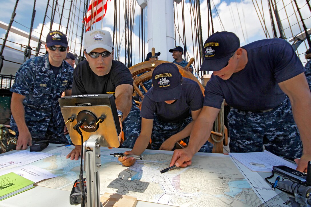 Navy Lt. Julien Geiser, second from left, and the navigation team plot a course through Boston Harbor while commemorating the battle between the USS Constitution and HMS Guerriere during the War of 1812, Aug. 19, 2012. Geiser is the USS Constitution’s operations officer.