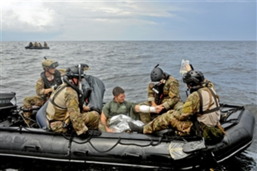 Pararescuemen apply buddy care to Air Force Senior Airman Rudy Parsons during a water rescue exercise in the Gulf of Mexico, Aug. 14, 2012. The team applied an IV to Parsons in choppy water to ensure the training was as realistic as possible. The pararescuemen are assigned to the 38th Rescue Squadron on Moody Air Force Base, Ga.