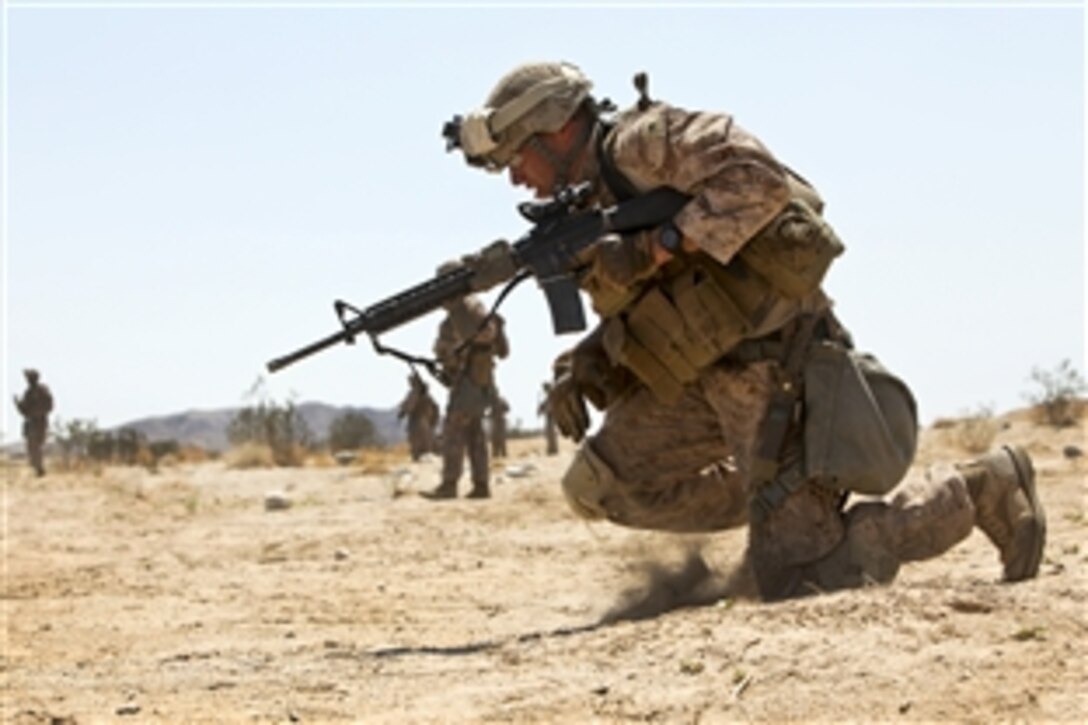 Marine Corps Lance Cpl. Luis Garces kneels to the ground while conducting buddy rushes during a leaders' course with about 150 Marines on Marine Corps Base Camp Pendleton, Calif., Aug. 14, 2012. Garces is a rifleman assigned to Bravo Company, 1st Battalion, 4th Marine Regiment.