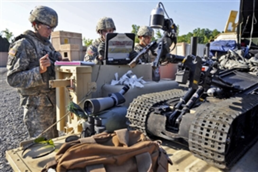 Army Sgt. Matthew Bagley, left, Staff Sgt. Christopher Thompson, center, and Staff Sgt. Josue Sandoval prepare their gear during the competition for Explosive Ordnance Disposal Team of the Year on Fort Knox, Ky., Aug. 16, 2012. Bagley, Thompson and Sandoval are assigned to the 663rd Ordnance Company, 242nd Explosive Ordnance Disposal Battalion, Fort Carson, Colo.