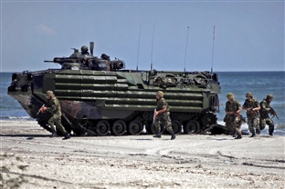 U.S. Marine Corps amphibious assault vehicles land on the beach carrying U.S. and Romanian troops during the final event of Exercise Summer Storm 12 on Capu Midia, Romania, Aug. 14, 2012. The Marines are assigned to Security Cooperation Task Force Africa Partnership Station 2012.