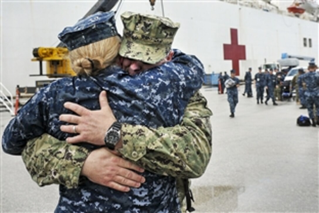 Navy Petty Officer 1st Class Michael Cowan greets his his wife, Senior Chief Shannon Cowan, after his return to Guam, Aug. 20, 2012, from a four-and-a-half month humanitarian assistance mission in Southeast Asia aboard the Military Sealift Command hospital ship USNS Mercy. The  Mercy participated in Pacific Partnership 2012, the largest annual humanitarian and civic action mission in the Asia-Pacific region.