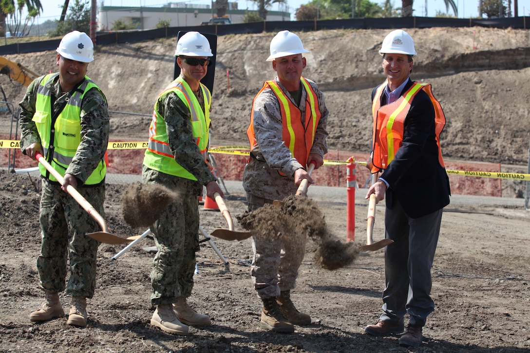 (left to right) Cmdr. Augustus Lim, public works officer for MCB Camp Pendleton; Navy Capt. Marko Medved, officer in charge of construction for Marine Corps Installations West; Col. Shaun Sadler, commanding officer of Marine Aircraft Group 39, I Marine Expeditionary Force, and Jeff Harper, president of Harper Construction, shovel dirt at a ground breaking ceremony for two future bachelor enlisted quarters in the 24 Area here, Aug. 21. The two projects combined will provide 430 two-man room quarters totaling 218,000 square feet, and achieve a Leadership in Energy and Environmental Design Gold Rating. The projects are scheduled for completion on Oct. 13, 2013.