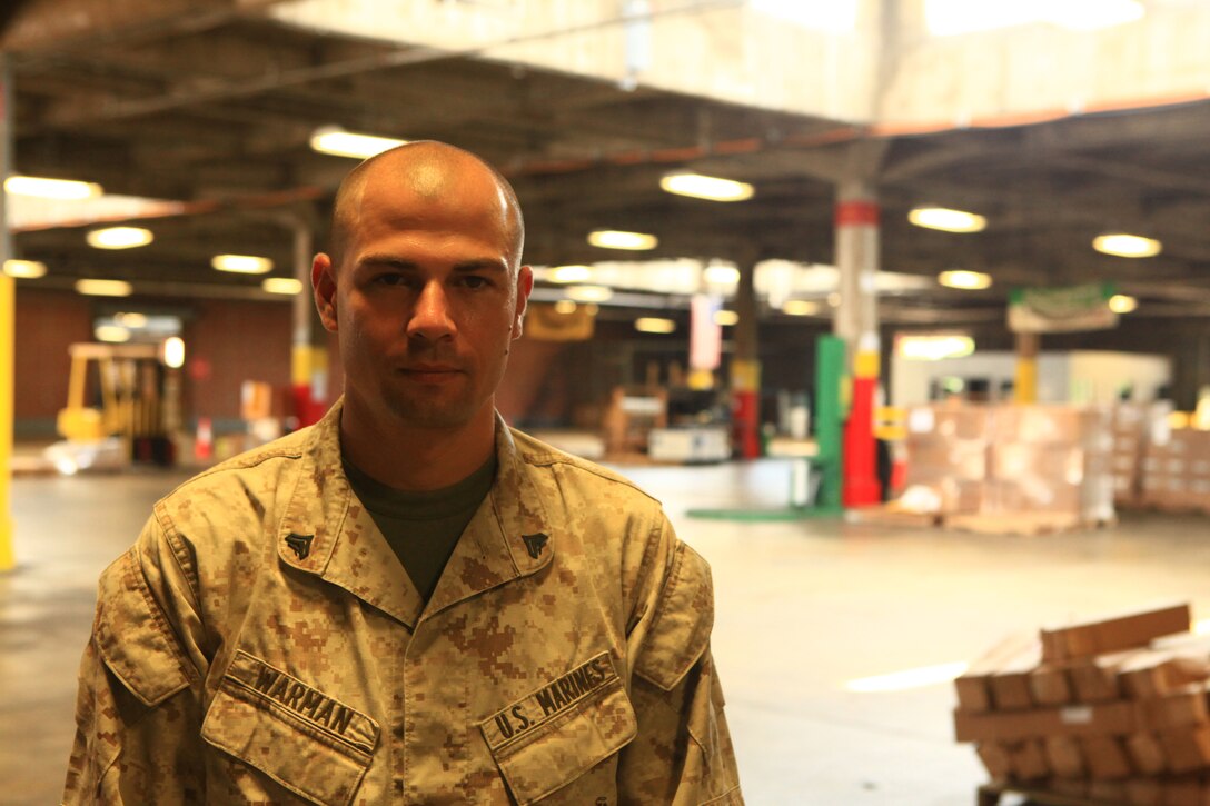 Cpl. Samuel L. Warman, a distribution management specialist with 2nd Supply Battalion, 2nd Marine Logistics Group, stands before a recently emptied warehouse aboard Camp Lejeune, N.C., Aug. 16, 2012. Warman, who was recognized by the Greater Jacksonville Chamber of Commerce as the servicemember of the month, helps manage and mentor the team of Marines responsible for distributing the equipment that commonly fills the warehouse. (Photo by Lance Cpl. Paul Peterson)
