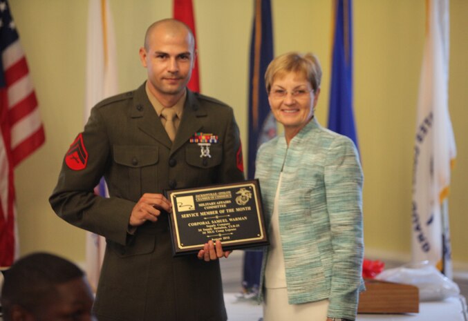 Cpl. Samuel L. Warman, a distribution management specialist with 2nd Supply Battalion, 2nd Marine Logistics Group, poses for a picture after receiving an award from a representative of the Greater Jacksonville Chamber of Commerce at the Officer’s Club aboard Camp Lejeune, N.C., Aug. 20, 2012. Warman was selected as the servicemember of the mouth for his professionalism, contributions to the community and history of service.  (Photo by Lance Cpl. Paul Peterson)