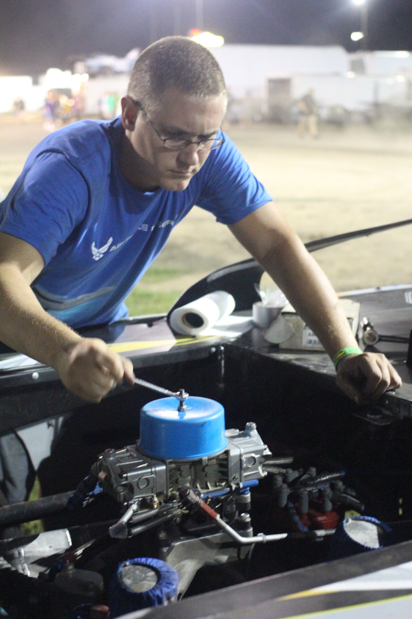 Airman 1st Class Adam Broeckling works on the engine of a Salty Dog Racing car in between heats. (U.S. Air Force photo by Tech. Sgt. Christopher Parr)