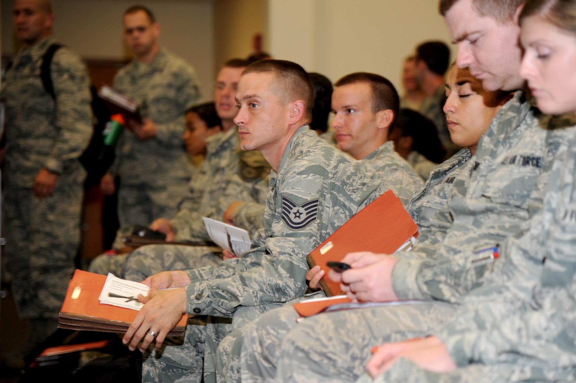 Tech. Sgt. Brock Hodge, 81st Diagnostic and Therapeutics Squadron, sits among other “deploying personnel” after going through a pre-deployment processing line at the Roberts Consolidated Aircraft Maintenance facility Aug. 22, 2012, during a two-day deployment exercise at Keesler Air Force Base, Miss.  (U.S. Air Force photo by Kemberly Groue)