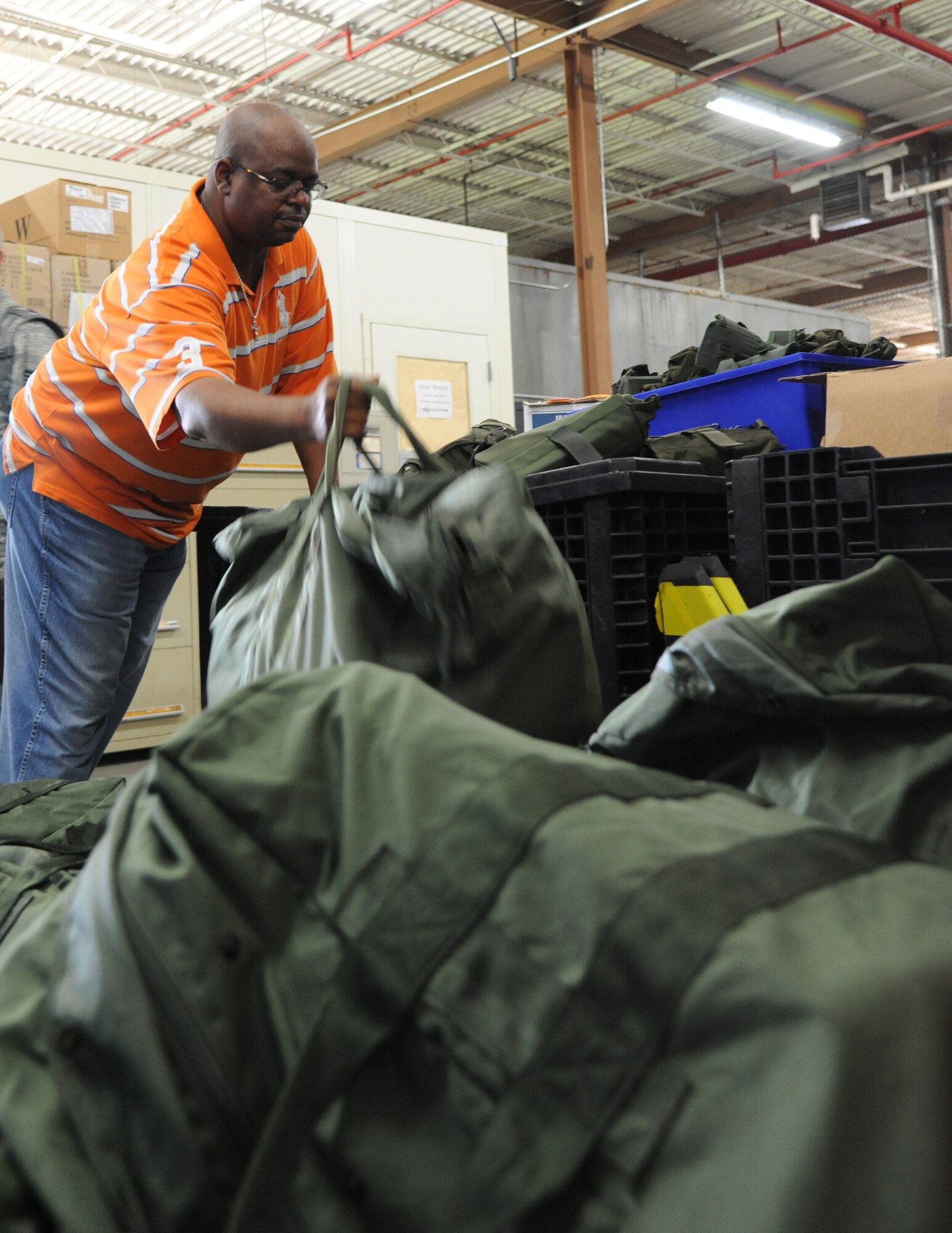 Nate Parks, CSC, stacks mobility bags for processing at the Taylor Logistics Center during a two-day deployment exercise Aug. 21, 2012, at Keesler Air Force Base, Miss.  (U.S. Air Force photo by Kemberly Groue)