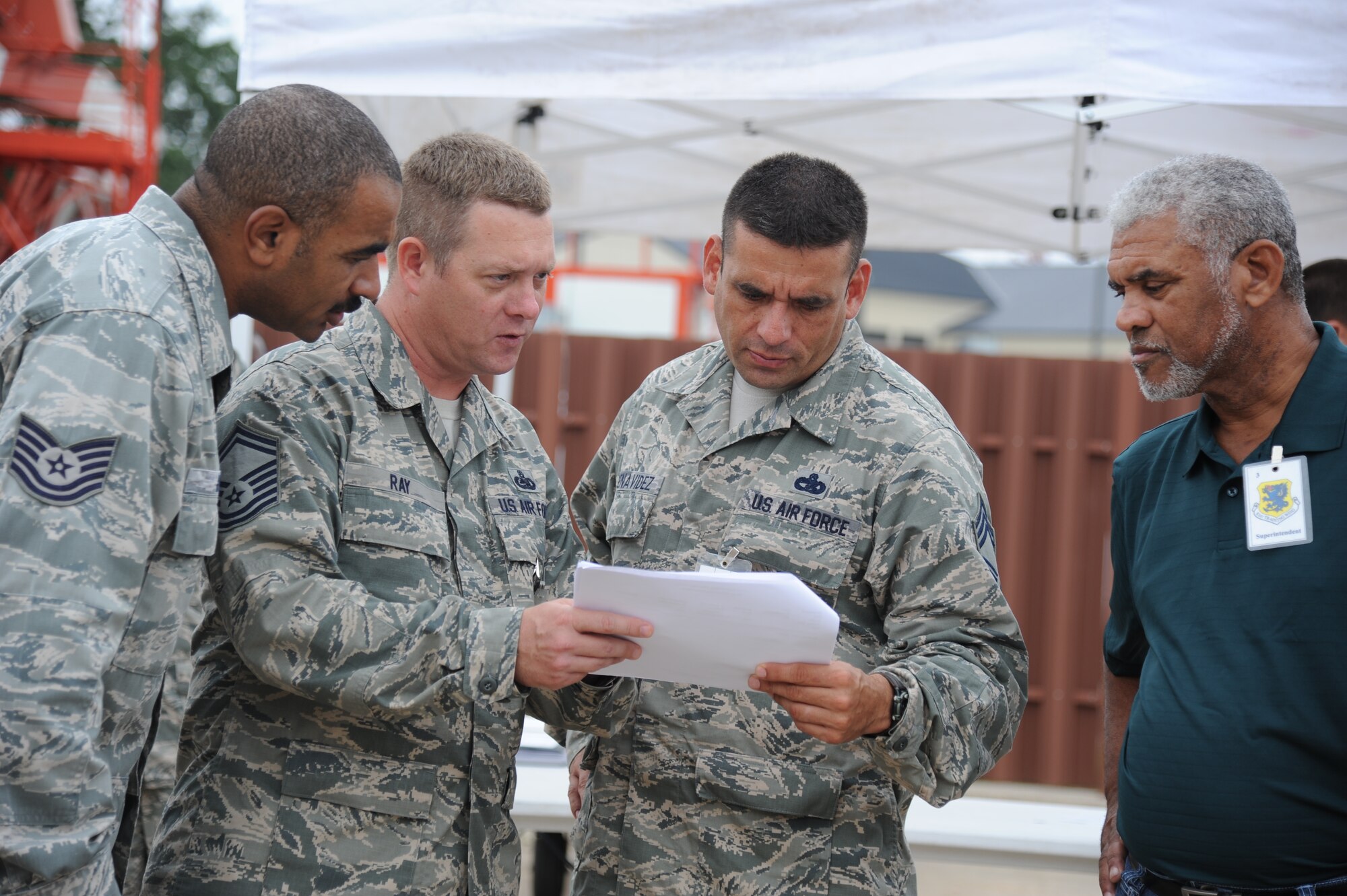 Tech. Sgt. Keir Bryant, Senior Master Sgt. Chris Ray, Chief Master Sgt. Juan Benavidez and Hank Watson, 81st Logistics Readiness Squadron, review the deployment schedule of events at the Taylor Logistics Center during a two-day deployment exercise Aug. 21, 2012, at Keesler Air Force Base, Miss.  (U.S. Air Force photo by Kemberly Groue)