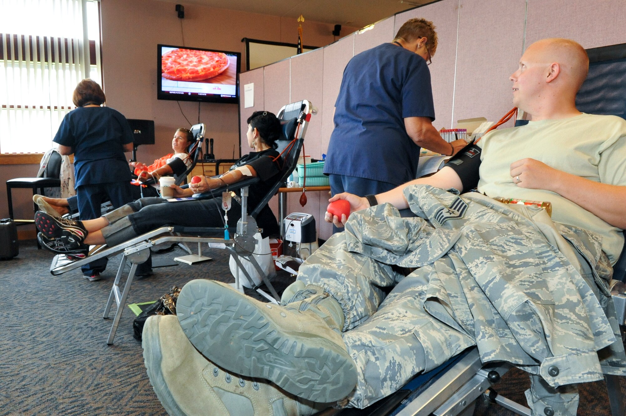 BUCKLEY AIR FORCE BASE, Colo. – Staff Sgt. Colby Hughbanks, right, 460th Medical Group, is ready to donate blood to the Bonfils Blood Center in Denver at Newtch’s Den Aug. 20, 2012. According to the Bonfils website, the increased awareness and demand for blood plasma didn’t come about until World War II. At that time, Americans supporting the war effort at home realized the importance of blood transfusions in order to save lives. (U.S. Air Force photo by Senior Airman Christopher Gross)