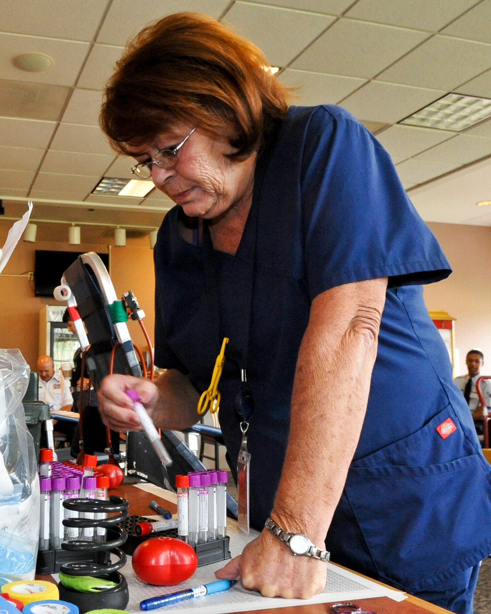 BUCKLEY AIR FORCE BASE, Colo. – Dianna Sax restocks test tubes at Newtch’s Den Aug. 20, 2012. Sax is with the Bonfils Blood Center in Denver, one of three locations for the Blood Bank of Colorado. The others are in Pueblo and Sterling. Approximately 40 Team Buckley members donated blood. (U.S. Air Force photo by Senior Airman Christopher Gross)