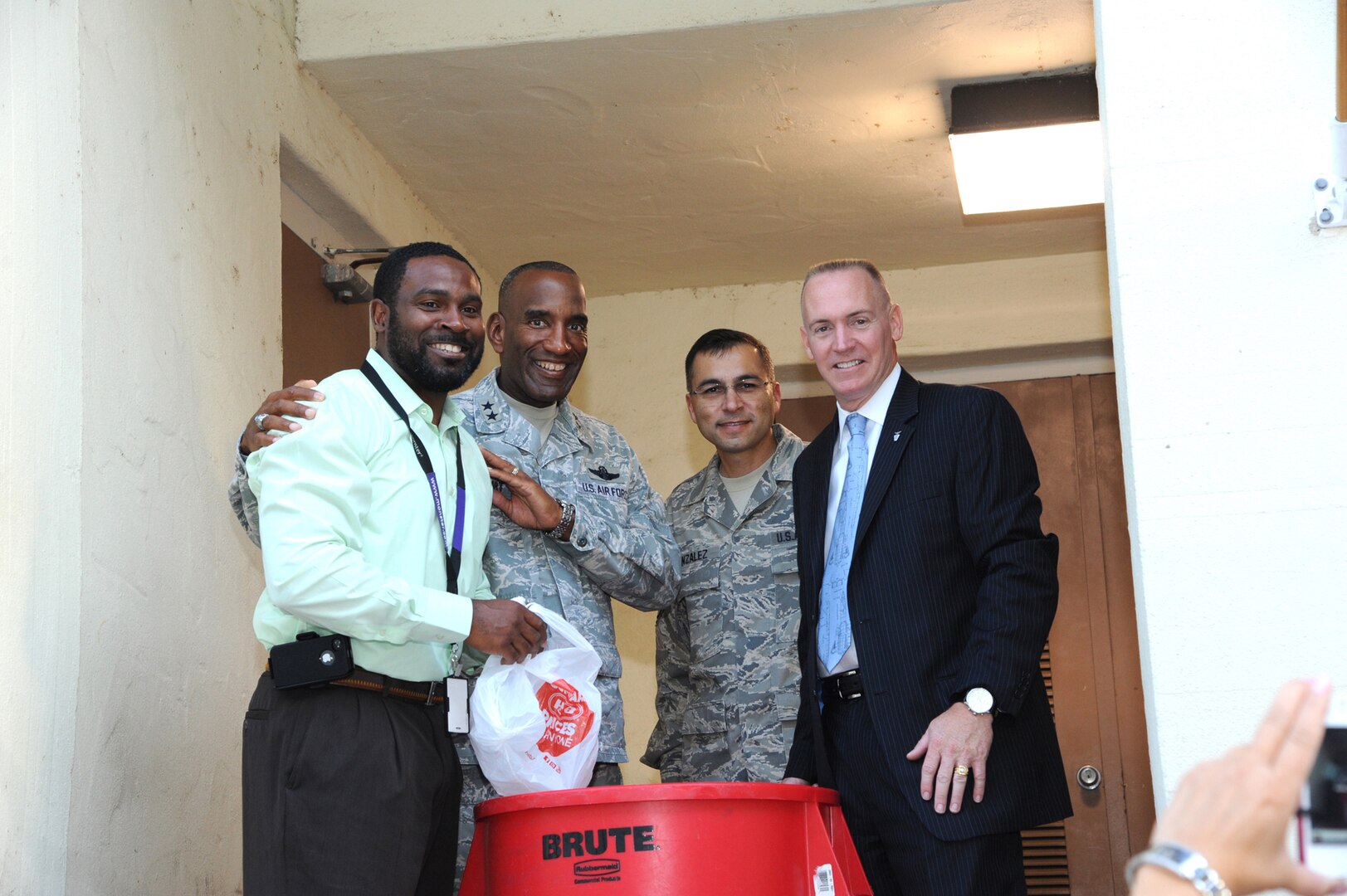 Maj. Gen. Alfred Stewart (second from left) , Air Force Personnel Center commander, joins Jacob Love, AFPC entitlements branch, Chief Master Sgt. Rubin Gonzales, AFPC command chief and Todd Fore, AFPC executive director, at a Feds Feeds Families food bank donation barrel during a collection event held at AFPC on Joint Base San Antonio-Randolph, Texas Aug. 15. (U.S. Air Force photo by Rich McFadden)