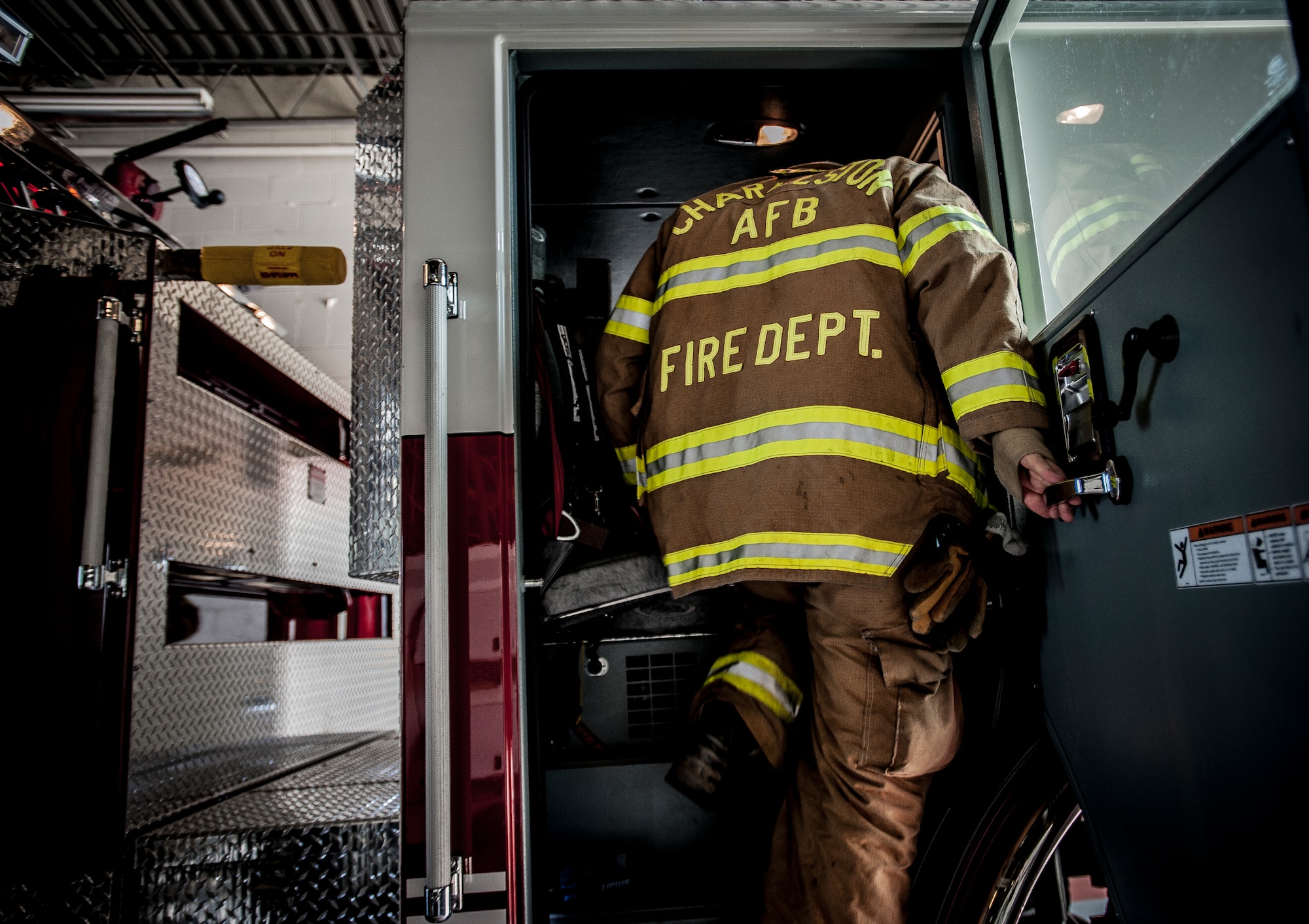 Staff Sgt. Anthony Ankeny, 628th Civil Engineer Squadron firefighter,  climbs into a fire truck during a drill Aug. 9, 2012, at Joint Base Charleston – Air Base, S.C. Each firefighter has six pieces of equipment to put on in less than two minutes when responding to an emergency call. (U.S. Air Force photo/Senior Airman Dennis Sloan)