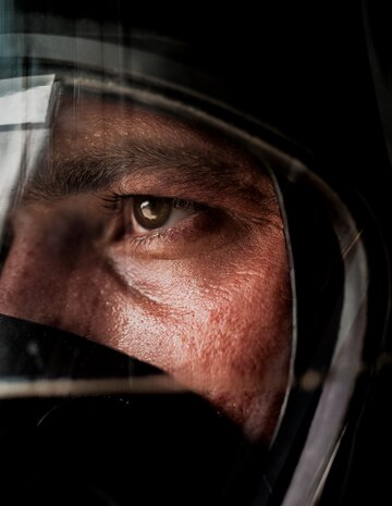 Staff Sgt. Anthony Ankeny, 628th Civil Engineer Squadron firefighter dons his oxygen mask before leaving the fire station during a drill Aug. 9, 2012, at Joint Base Charleston- Air Base, S.C. Each firefighter has six pieces of equipment to put on in less than two minutes when responding to an emergency call. (U.S. Air Force photo/Senior Airman Dennis Sloan)