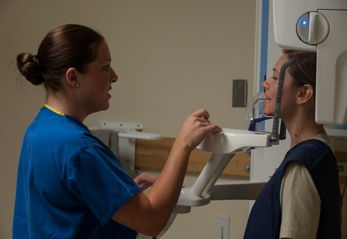 Senior Airman Tara Serrano, 628th Medical Group dental assistant, performs a routine dental X-ray on Staff Sgt. Sarah Strasen, 437th Operations Support Squadron airfield management training manager, during her dental appointment Aug. 17, 2012, at Joint Base Charleston - Air Base, S.C.  Dental assistants assist dentists with a patient’s annual exam and to ensure they are ready for deployment. (U.S. Air Force photo/Airman 1st Class Ashlee Galloway)