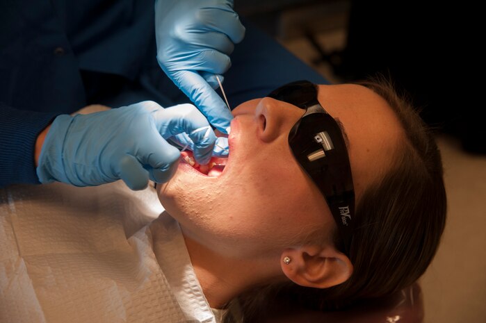 Senior Airman Tara Serrano, 628th Medical Group dental assistant, performs a routine dental exam on Staff Sgt. Sarah Strasen, 437th Operations Support Squadron airfield management training manager, during her dental appointment Aug. 17, 2012, at Joint Base Charleston - Air Base, S.C.  Dental assistants aid dentists in the performance of generalized tasks, including chair-side aid, clerical work, reception, and some radiography and dental laboratory work. (U.S. Air Force photo/Airman 1st Class Ashlee Galloway)