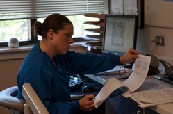 Senior  Airman Tara Serrano, 628th Medical Group dental assistant, looks through a patient’s chart before performing a routine dental exam Aug. 17, 2012, at Joint Base Charleston - Air Base, S.C. Dental assistants are trained to assist dentists with clinical and administrative procedures. (U.S. Air Force photo/Airman 1st Class Ashlee Galloway)