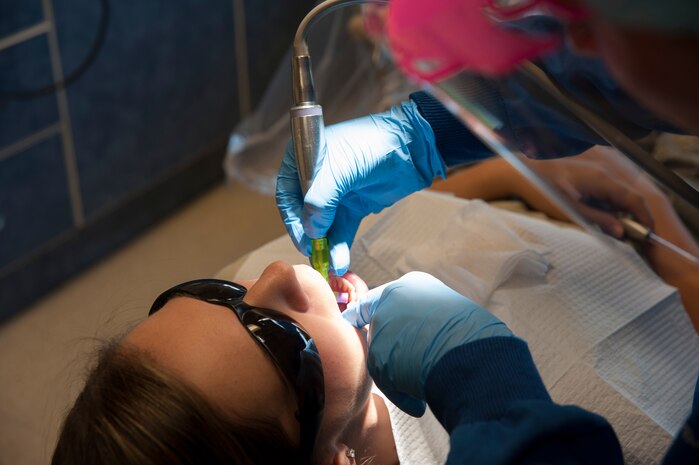 Senior Airman Tara Serrano, 628th Medical Group dental assistant, performs a routine dental exam on Staff Sgt. Sarah Strasen, 437th Operations Support Squadron airfield management training manager, during her dental appointment Aug. 17, 2012, at Joint Base Charleston - Air Base, S.C. Dental assistants perform exams and cleanings  to ensure patients are ready for deployment. (U.S. Air Force photo/Airman 1st Class Ashlee Galloway)