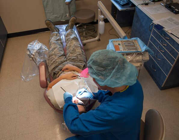 Senior Airman Tara Serrano, 628th Medical Group dental assistant, performs a routine dental exam on Staff Sgt. Sarah Strasen, 437th Operations Support Squadron airfield management training manager, during her dental appointment Aug. 17, 2012, at Joint Base Charleston - Air Base, S.C.  Dental assistants aid dentists in the performance of generalized tasks, including chair-side aid, clerical work, reception and some radiography and dental laboratory work. (U.S. Air Force photo/Airman 1st Class Ashlee Galloway)