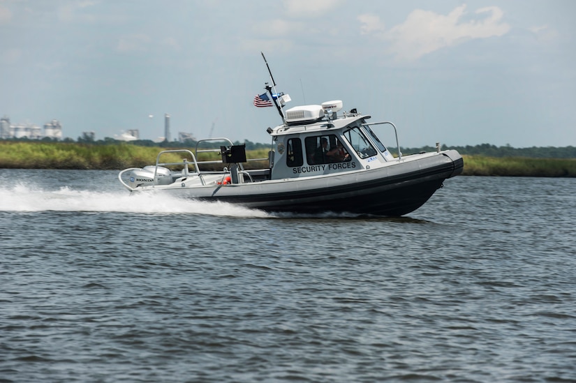 Officer Patrick Murphy and Staff Sgt. Neil White, 628th Security Forces Squadron Harbor Patrol Unit, simulate a high speed chase Aug. 15, 2012, at Joint Base Charleston - Weapons Station, S.C. The Harbor Patrol Unit's mission is to patrol and protect the waterways around JB Charleston – Weapons Station. (U.S. Air Force photo/Airman 1st Class Ashlee Galloway)