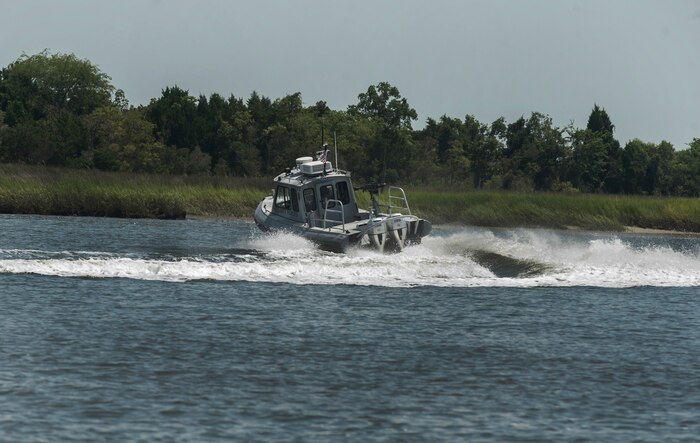 Officer Patrick Murphy and Staff Sgt. Neil White, 628th Security Forces Squadron Harbor Patrol Unit, simulate a high speed chase  Aug. 15, 2012, at Joint Base Charleston - Weapons Station, S.C. The Harbor Patrol Unit's mission is to patrol and protect the waterways around JB Charleston – Weapons Station. (U.S. Air Force photo/Airman 1st Class Ashlee Galloway)