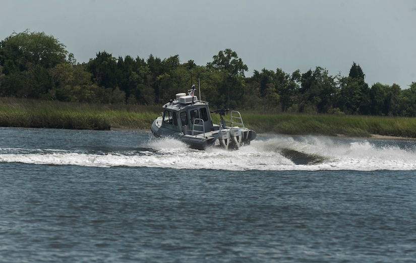 Officer Patrick Murphy and Staff Sgt. Neil White, 628th Security Forces Squadron Harbor Patrol Unit, simulate a high speed chase  Aug. 15, 2012, at Joint Base Charleston - Weapons Station, S.C. The Harbor Patrol Unit's mission is to patrol and protect the waterways around JB Charleston – Weapons Station. (U.S. Air Force photo/Airman 1st Class Ashlee Galloway)