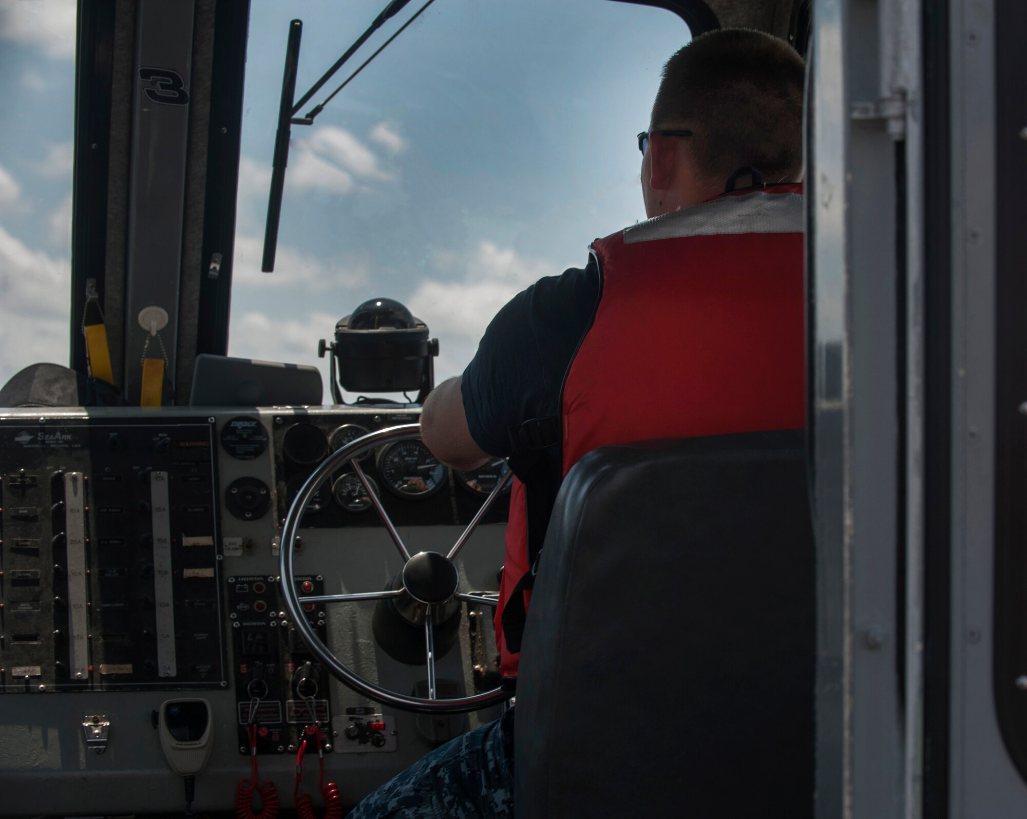 Master-at-Arms Second Class Petty Officer Michael Jones, 628th Security Forces Squadron Harbor Patrol Unit, drives a Sea Ark boat while on patrol Aug. 15, 2012, in the waters around Joint Base Charleston – Weapons Station, S.C. The Weapons Stations officers patrol the waterways  24-hours a day, seven days a week. (U.S. Air Force photo/Airman 1st Class Ashlee Galloway)