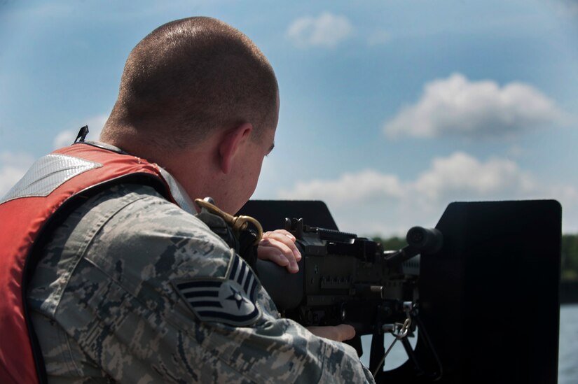 Staff Sgt. John Sweeney, 628th Security Forces Squadron Harbor Patrol Unit, demonstrates aiming an M240 machine gun while on patrol Aug. 15, 2012, at Joint Base Charleston - Weapons Station, S.C. The M240 has a weight of 27.6 lbs., a maximum effective range of 1,800 meters area target and 800 meters point target. The M240 can shoot from 200 to 600 rounds-per-minute. Officers from the Harbor Patrol Unit must be qualified on the M240 and the M60 machine gun. (U.S. Air Force photo/Airman 1st Class Ashlee Galloway)