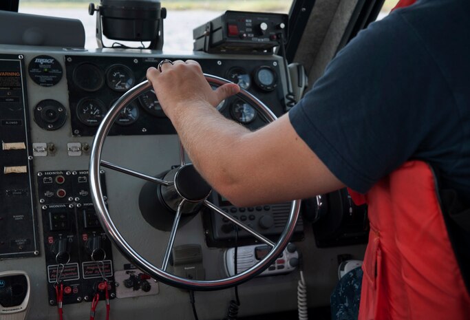 Master-at-Arms Second Class Petty Officer Michael Jones, 628th Security Forces Squadron Harbor Patrol Unit, drives a Sea Ark boat while on patrol Aug. 15, 2012 at Joint Base Charleston - Weapons Station, S.C. The Weapons Station officers patrol the waterways around the base 24-hours a day, seven days a week. (U.S. Air Force photo/Airman 1st Class Ashlee Galloway)