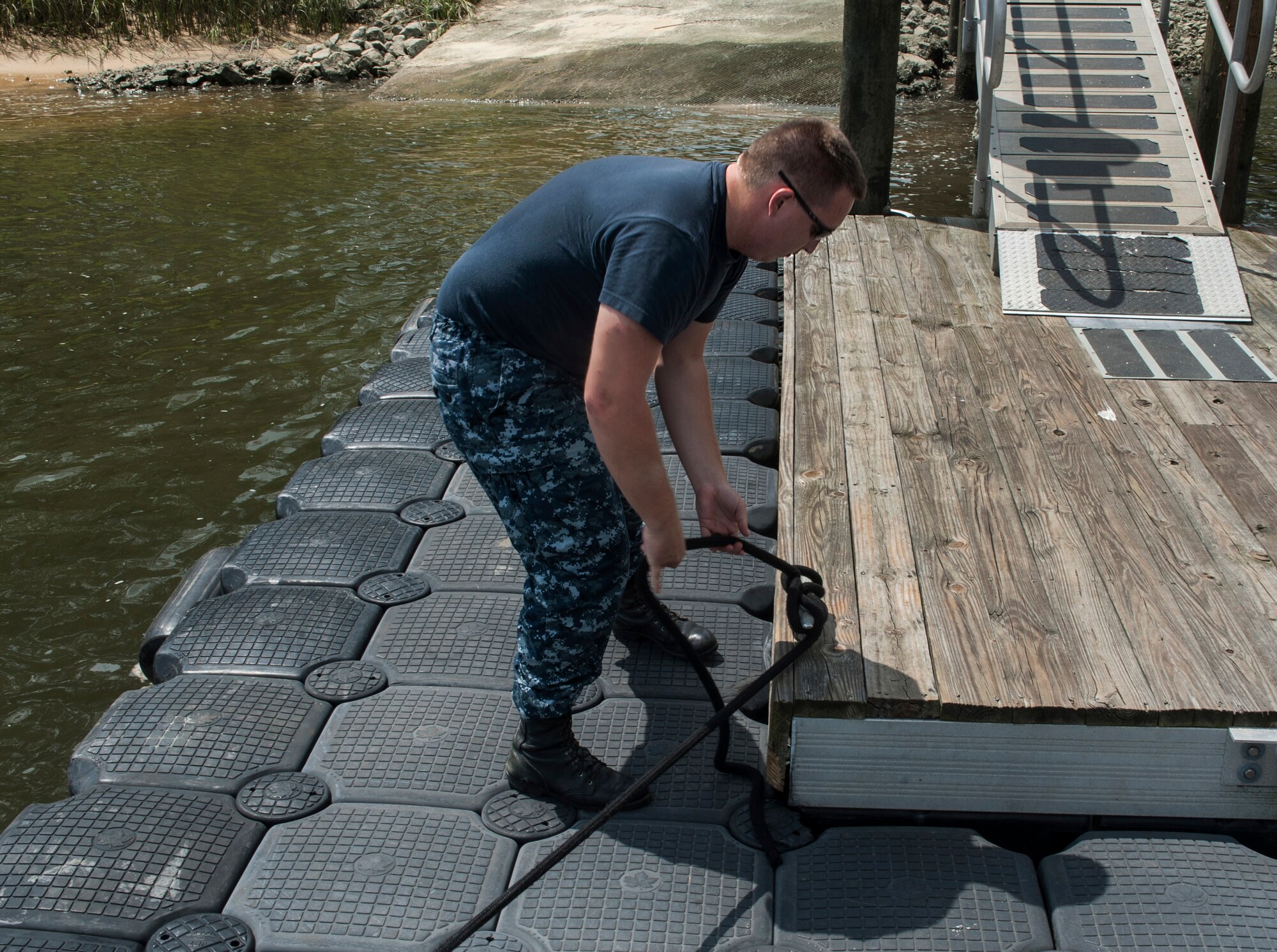 Master-at-Arms Second Class Petty Officer Michael Jones, 628th Security Forces Squadron Harbor Patrol Unit, ties down a Sea Ark boat after a patrol Aug. 15, 2012, at Joint Base Charleston - Weapons Station, S.C. The 628th SFS officers patrol the waterways around the base 24-hours a day, seven days a week. (U.S. Air Force photo/Airman 1st Class Ashlee Galloway)