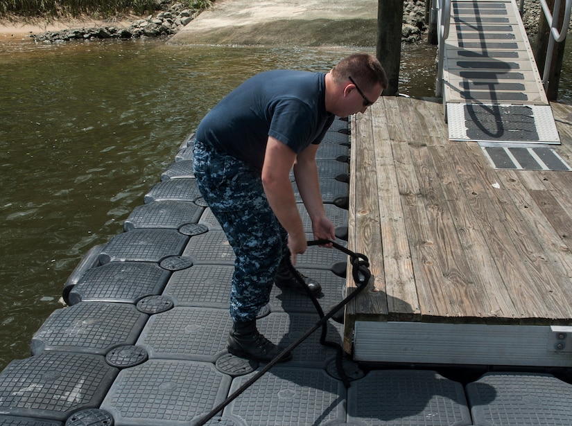 Master-at-Arms Second Class Petty Officer Michael Jones, 628th Security Forces Squadron Harbor Patrol Unit, ties down a Sea Ark boat after a patrol Aug. 15, 2012, at Joint Base Charleston - Weapons Station, S.C. The 628th SFS officers patrol the waterways around the base 24-hours a day, seven days a week. (U.S. Air Force photo/Airman 1st Class Ashlee Galloway)