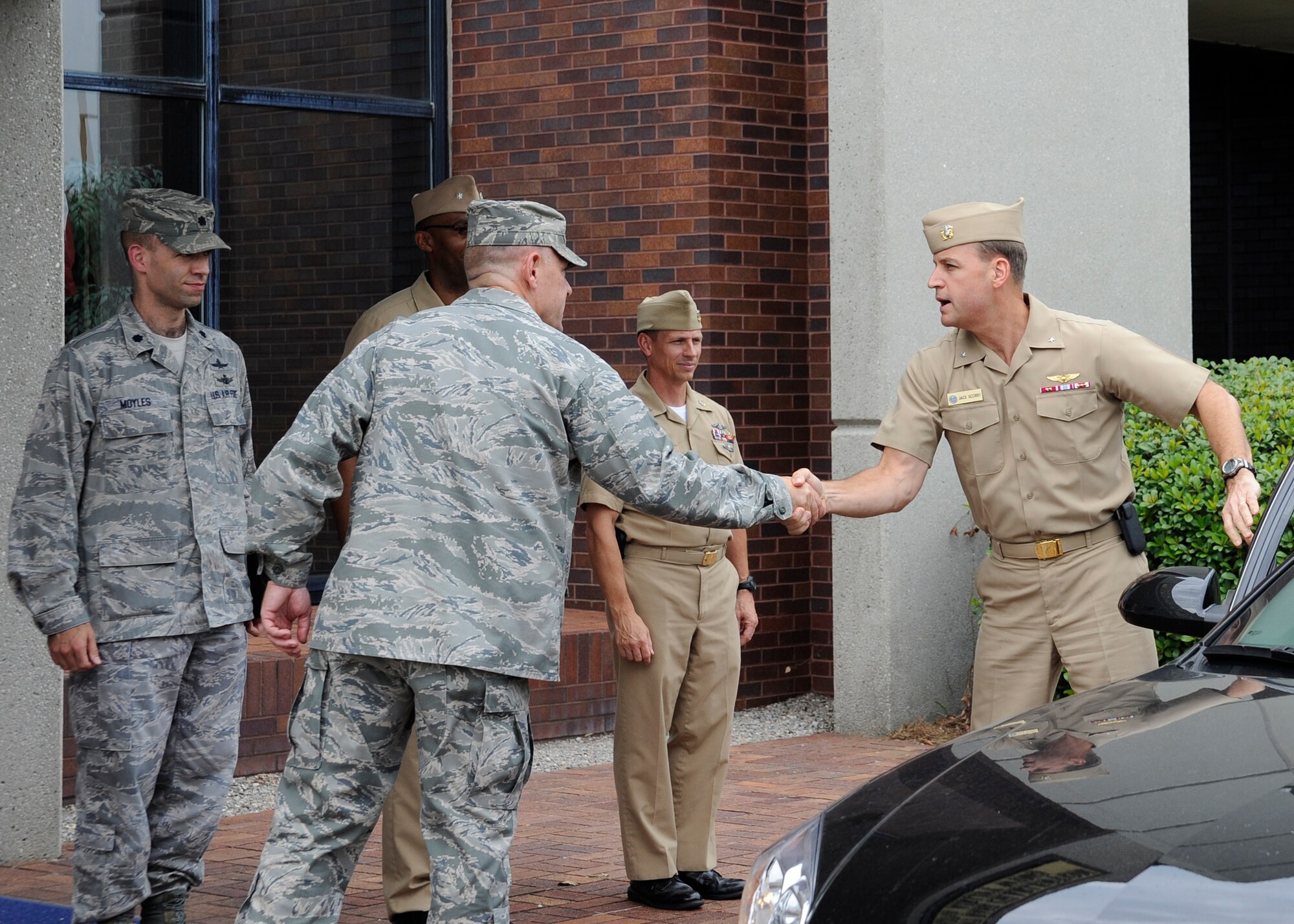 Col. Richard McComb, Joint Base Charleston commander, greets Rear Adm. John "Jack" Scorby Jr., Navy Region Southeast commander, at Joint Base Charleston – Air Base, S.C., Aug. 16, 2012. Scorby is responsible for 17 shore facilities across the Southeast United States and Caribbean. Scorby visited facilities on JB Charleston – Air Base and JB Charleston – Weapons Station. (U.S. Air Force photo/ Staff Sgt. Rasheen Douglas)