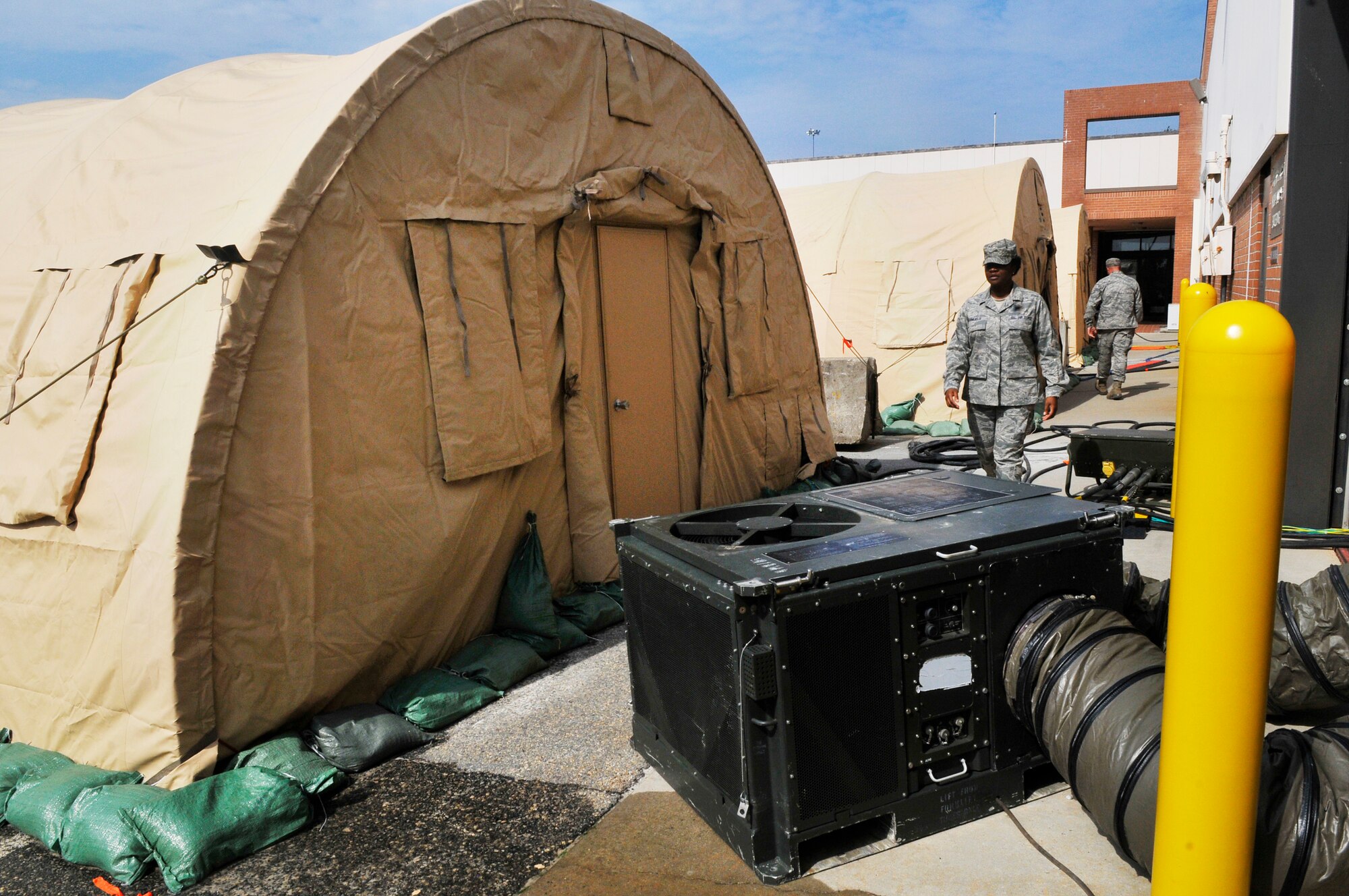 The 51st Combat Communications Squadron have set up temporary work  centers in and around Bldg. 963 including three tents with A/C, generators, etc. while air conditioning work is being done in that building. (U. S. Air Force photo/Sue Sapp)