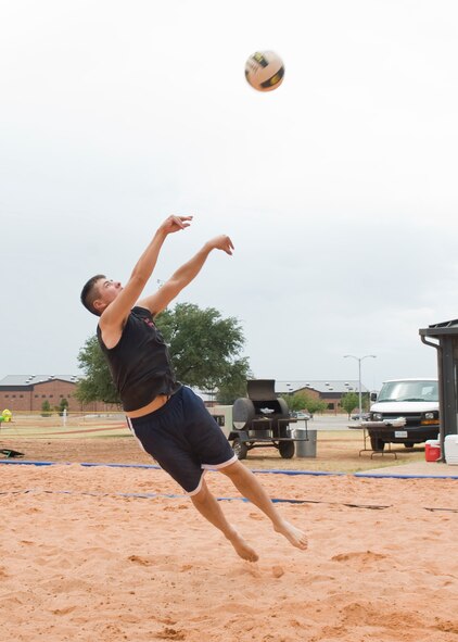U.S. Air Force Capt. Nick Saccone, 819th Red Horse Squadron, from Malmstrom Air Force Base, Mont., sets a stray ball during a 2-on-2 volleyball match Aug. 18, 2012, on Dyess Air Force Base, Texas. The recently constructed sand volleyball court was made to benefit Airmen living in the dorms and bring business to the Hangar Center. Many local businesses and organizations donated money and time toward the court. The Company Grade Officers Club and Red Horse Airmen from Malmstrom AFB, Mont., volunteered their time for three weeks to move 220 tons of sand, donated by Ingram concrete. (U.S. Air Force Photo by Airman 1st Class Peter Thompson/ Released)