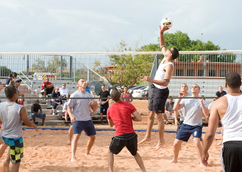 U.S. Air Force 1st Lt. Edwin Cruz, 317th Airlift Group, spikes a ball during a 6-on-6 volleyball match Aug. 18, 2012, at Dyess Air Force Base, Texas. The recently constructed sand volleyball court was made to benefit Airmen living in the dorms and bring business to the Hangar Center. Many local businesses and organizations donated money and time toward the court. The Company Grade Officers Club and Red Horse Airmen from Malmstrom AFB, Mont., volunteered their time for three weeks to move 220 tons of sand, donated by Ingram concrete. (U.S. Air Force Photo by Airman 1st Class Peter Thompson/ Released)