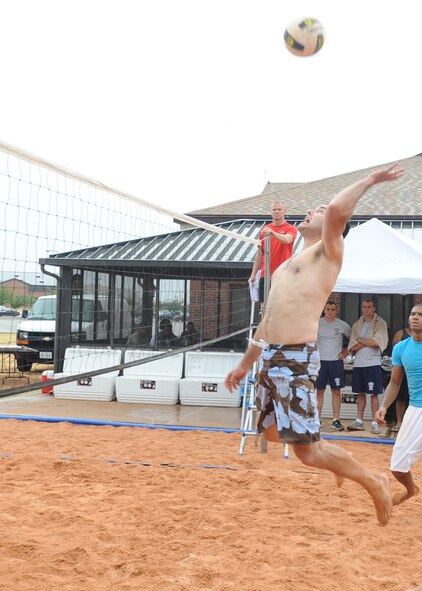 U.S. Air Force Col. Vincent Lostetter, 7th Bomb Wing vice commander, spikes a ball during a 6-on-6 volleyball match Aug. 18, 2012, at Dyess Air Force Base, Texas. The recently constructed sand volleyball court was made to benefit Airmen living in the dorms and bring business to the Hangar Center. Many local businesses and organizations donated money and time toward the court. The Company Grade Officers Club and Red Horse Airmen from Malmstrom AFB, Mont., volunteered their time for three weeks to move 220 tons of sand, donated by Ingram concrete. (U.S. Air Force Photo by Airman 1st Class Peter Thompson/ Released) 