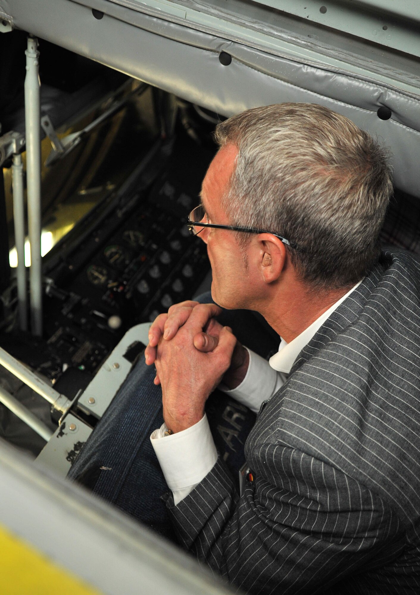 RAF MILDENHALL, England – Stuart Cook, a local business owner, looks out the boom operator’s pod of a KC-135 Stratotanker as part of a base tour Aug. 21, 2012, on the flightline. Following a ride in the KC-135 flight simulator, the group was given a tour the aircraft where they had the opportunity to climb into the boom pod and sit in the pilot and co-pilot seats in the flight deck. (U.S. Air Force photo/Senior Airman Jerilyn Quintanilla)