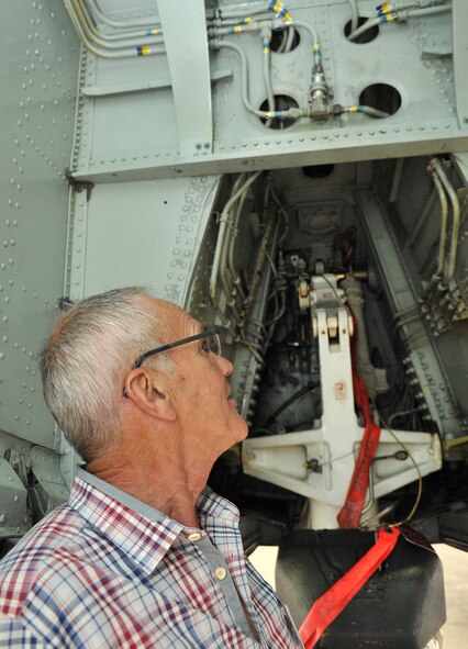 RAF MILDENHALL, England – Terry Hamill, a worker at a local autistic home, takes a look at parts of the landing gear of a KC-135 Stratotanker Aug. 21, 2012, on the flightline. Hamill and seven other members of the local community were invited by the British-American Committee for a tour of the base. The tour also consisted of wing mission brief, visits to the air traffic control tower, a ride in the KC-135 Stratotanker flight simulator and a tour of a static aircraft on the flightline. (U.S. Air Force photo/Senior Airman Jerilyn Quintanilla)