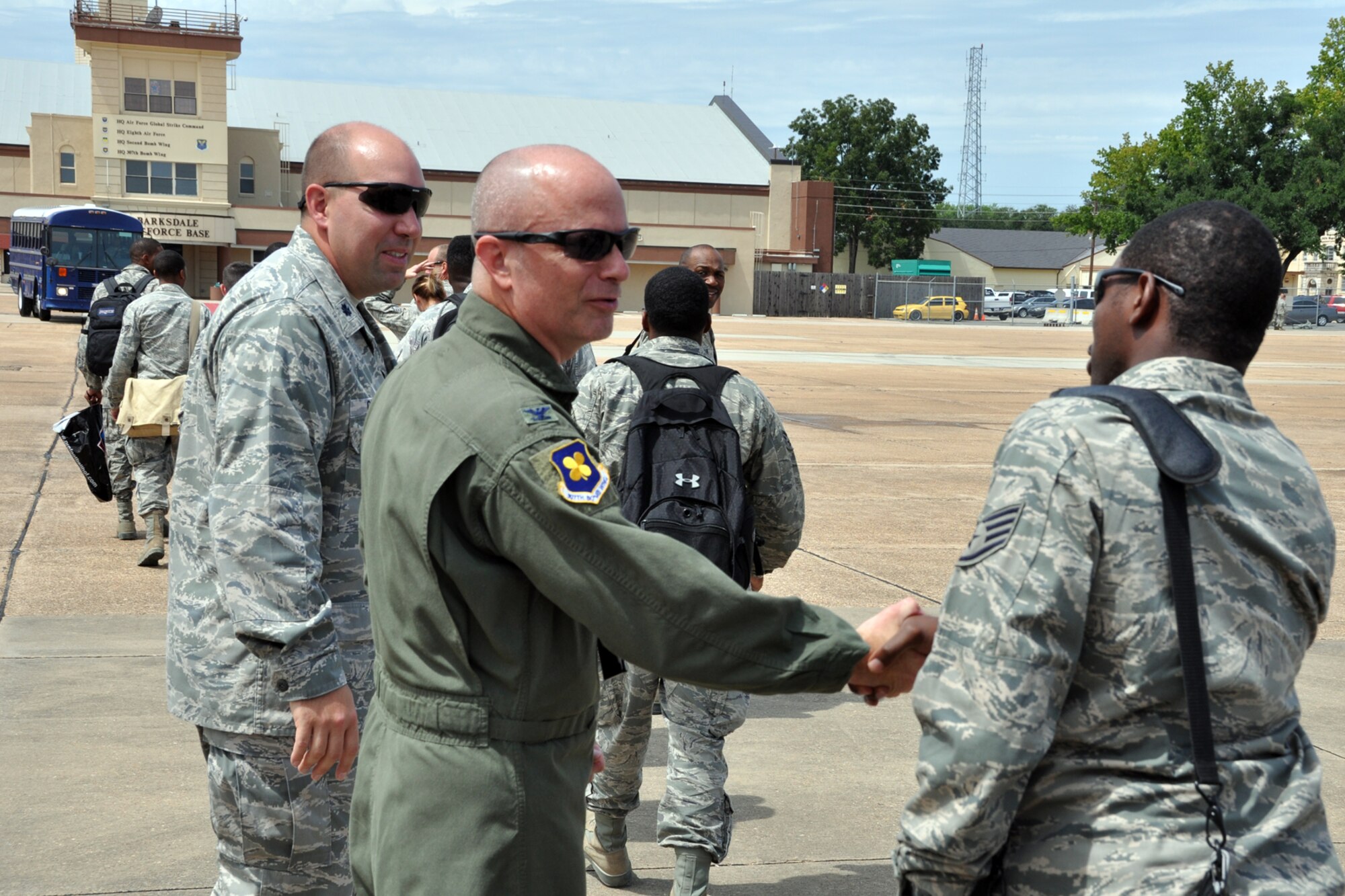 Col. Jonathan Ellis, commander of the 307th Bomb Wing and Lt. Col. Charles B. Chapman III, commander of the 307th Civil Engineer Squadron welcome home a group of 307 BW Airmen at Barksdale Air Force Base, La., Aug. 17, 2012. The Airmen made up a 29-person detail from the 307 CES that spent two weeks at Youngstown Air Reserve Station, Vienna, Ohio, assisting the 910 Civil Engineer Squadron build a Prime Base Engineer Emergency Force (Prime BEEF) training area. (U.S. Air Force photo by Master Sgt. Jeff Walston) 